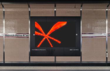 A platform at the Heinrich-Heine-Allee subway station in Düsseldorf where an advertising screen displays a video work by Yoora Park.