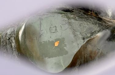 A close-up view of the Henry Moore sculpture in Düsseldorf's Hofgarten, the outlines are blurred, the eye-shaped close-up of the steel sculpture bears marks from weathering and human intervention.